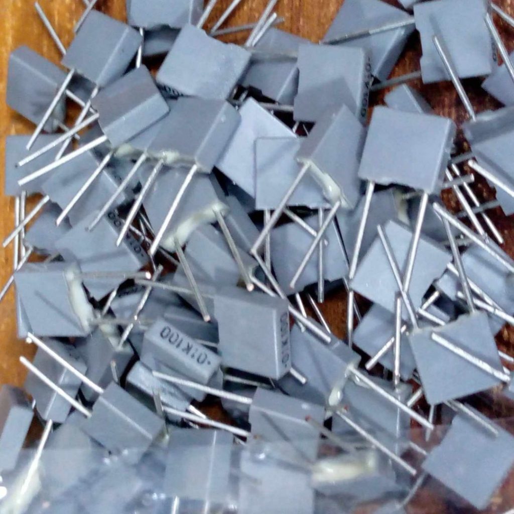 Picture of 10Pcs - BOX TYPE 10nF 103J 0.01uf 100VAC Electric Power Polypropylene Metal Film Box Capacitor Axial Film Molded 100nF 100VAC Capacitors 2 Pin Leads Connections Leg