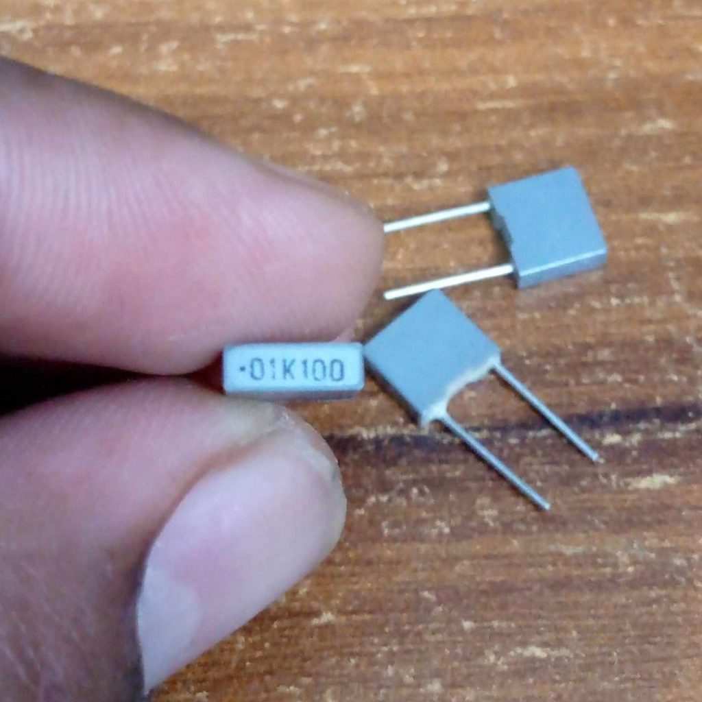 Picture of 10Pcs - BOX TYPE 10nF 103J 0.01uf 100VAC Electric Power Polypropylene Metal Film Box Capacitor Axial Film Molded 100nF 100VAC Capacitors 2 Pin Leads Connections Leg