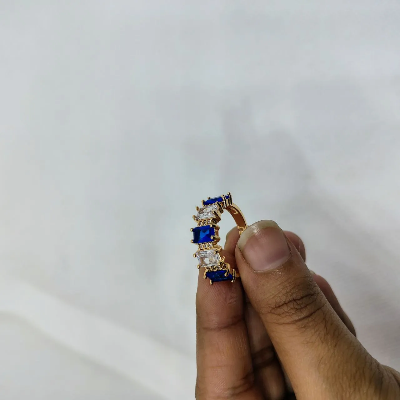 Picture of vibrant gold ring adorned with colorful gemstones,