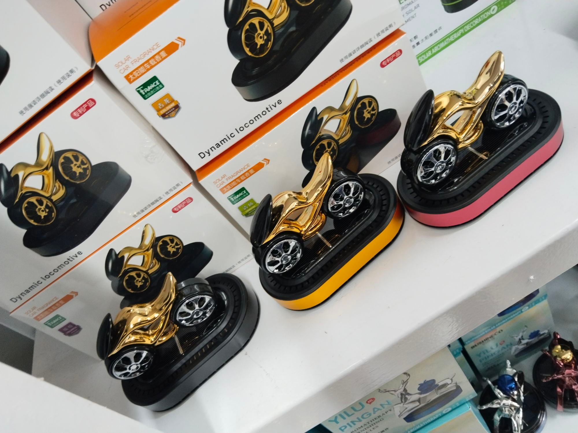 Picture of Bike Shape Car Dashboard Perfume – Stylish Solar Rotating Air Freshener Gold