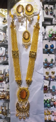 Picture of Elegant gold-plated jewelry set for women. Includes long necklace, earrings, and tikli. Perfect for wedding, party, and traditional wear. High-quality finish and stylish design.
