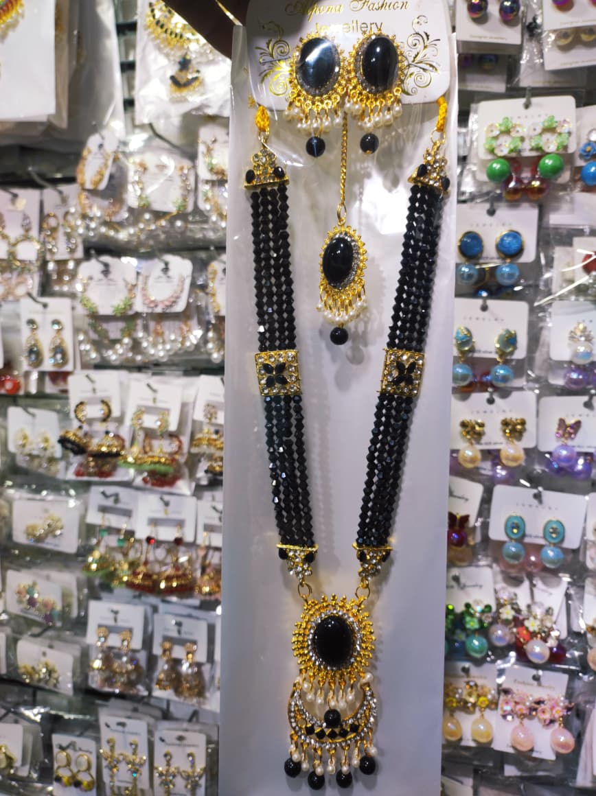 Picture of Elegant gold-plated jewelry set for women. Includes long necklace, earrings, and tikli. Perfect for wedding, party, and traditional wear. High-quality finish and stylish design.