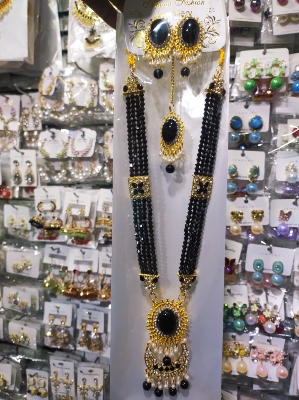 Picture of Elegant gold-plated jewelry set for women. Includes long necklace, earrings, and tikli. Perfect for wedding, party, and traditional wear. High-quality finish and stylish design.