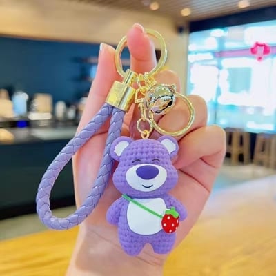 Picture of Cute 3D Strawberry Bear Keychain – Kawaii Knitted-Texture Cartoon Bear Bag Charm with Braided Leather Strap & Bell for Girls/Kids (Purple)