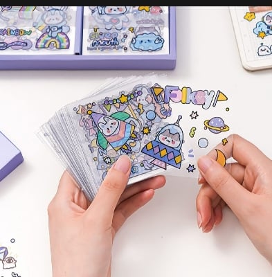 Picture of 100 Sheets Stickers Box Galaxy Dream Anime Figure Pattern Decorative PET Cartoon Character Decals for Scrapbook-Purple
