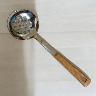 Picture of Single Piece 10 Inch Stainless Steel Round Slotted Kitchen Spoon, Silver, with Non-Magnetic Wooden Color Plastic Handle Cover. Perfect for Cooking and Serving, Durable and Stylish for Any Kitchen.-Silver