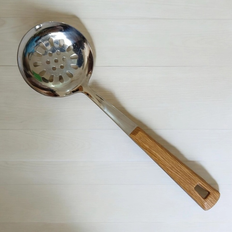 Picture of Single Piece 10 Inch Stainless Steel Round Slotted Kitchen Spoon, Silver, with Non-Magnetic Wooden Color Plastic Handle Cover. Perfect for Cooking and Serving, Durable and Stylish for Any Kitchen.-Silver