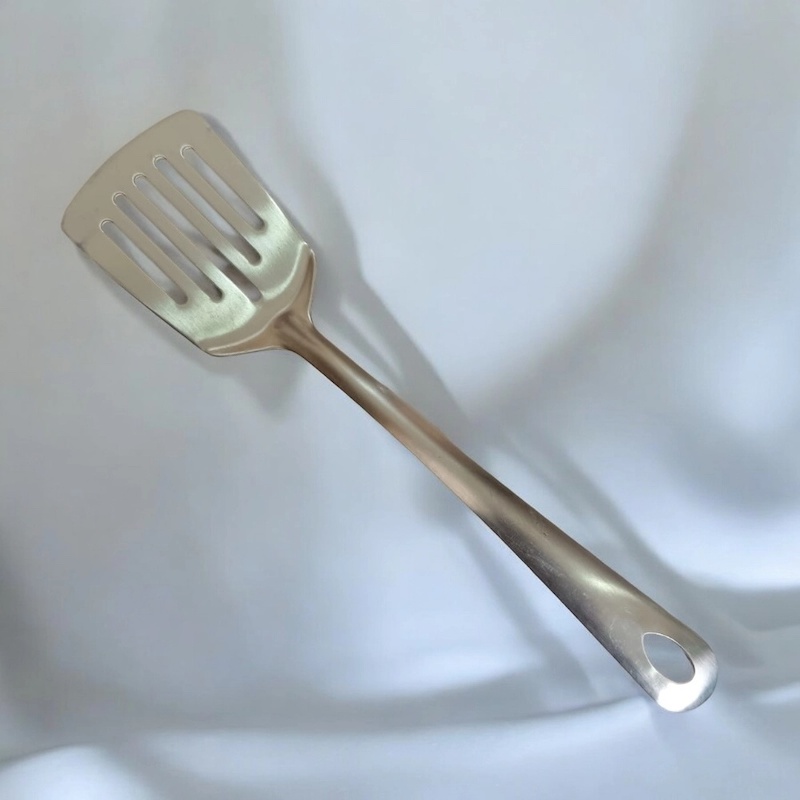 Picture of 10 Inch Slotted Turner Spoon, Silver Stainless Steel, Non-Magnetic. Ideal for Cooking and Serving, Combines Durability and Efficiency for Flipping and Serving Foods.-Silver