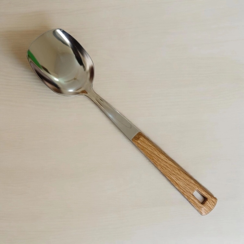 Picture of 10 Inch Solid Turner Spoon, Silver Stainless Steel, Non-Magnetic. Features Wooden Color Cover Plastic Handle. Perfect for Cooking and Serving, Effortless Flipping in Any Kitchen.-Silver