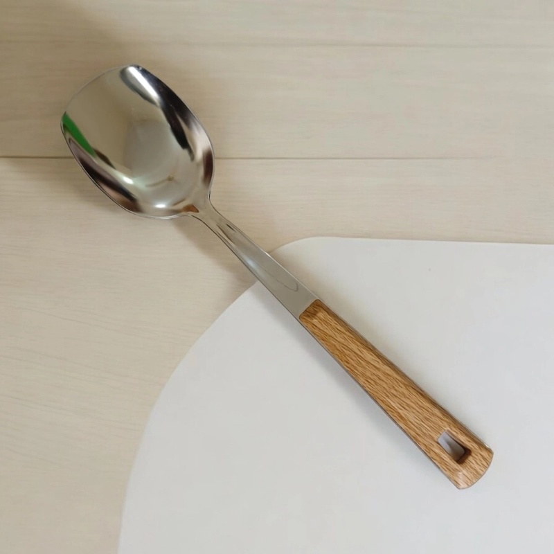 Picture of 10 Inch Solid Turner Spoon, Silver Stainless Steel, Non-Magnetic. Features Wooden Color Cover Plastic Handle. Perfect for Cooking and Serving, Effortless Flipping in Any Kitchen.-Silver