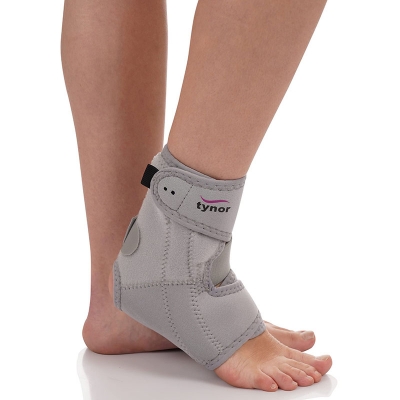 Picture of Tynor Ankle Support (Neoprene) is designed to give support, compression and controlled immobilization to weak or injured ankle. The stabilizing splint, supports the ankle where it is most needed, to prevent an ankle injury. it can be used in high impact-h Grey