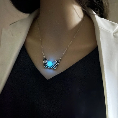 Picture of Product Description: Fashion Halloween Skull Palm Heart Pendant Luminous Necklace Add an eerie yet enchanting touch to your style with the Luminous Skull Palm Heart Pendant Necklace. Blending gothic romance with a playful, spooky vibe, this statement chok - Blue