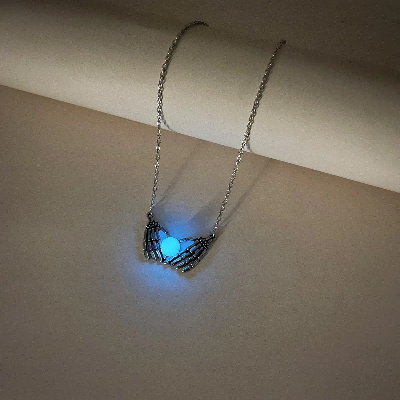 Picture of Product Description: Fashion Halloween Skull Palm Heart Pendant Luminous Necklace Add an eerie yet enchanting touch to your style with the Luminous Skull Palm Heart Pendant Necklace. Blending gothic romance with a playful, spooky vibe, this statement chok - Blue