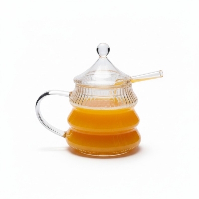 Picture of Premium 10oz Beehive Glass Juice Pot with Stirring Rod and Lid crafted from heat-resistant borosilicate glass perfect for serving fresh orange juice or fruit infusions at your modern breakfast dining table.