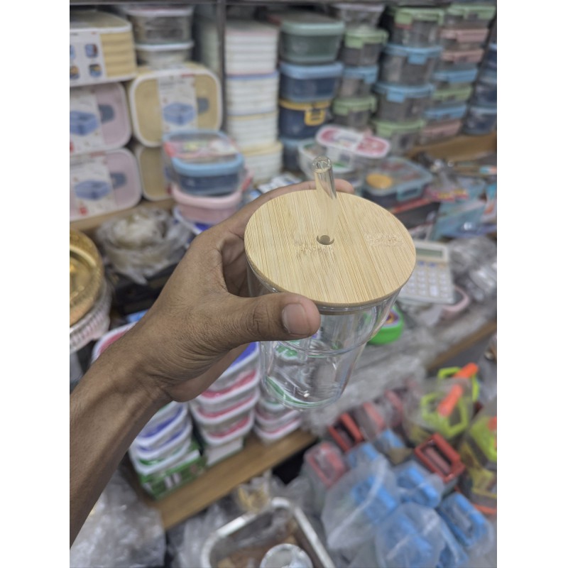 Picture of glass tumbler with a bamboo lid and a reusable glass straw,