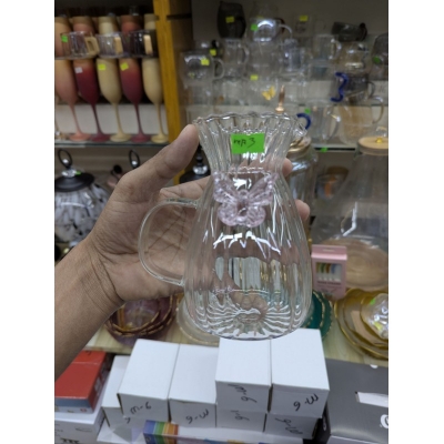 Picture of Elegant fluted borosilicate glass pitcher with pink butterfly motif and scalloped rim for serving fresh orange juice lemonade or iced tea at sophisticated garden parties brunch gatherings and stylish home dining events.