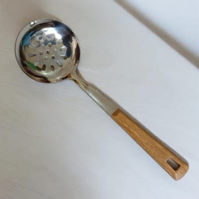Picture of 10 Inch Stainless Steel Round Slotted Kitchen Spoon, Silver, with Non-Magnetic Wooden Color Plastic Handle, Ideal for Cooking and Serving. This Durable and Stylish Spoon Enhances Versatility and Elegance in Your Kitchen.-Silver