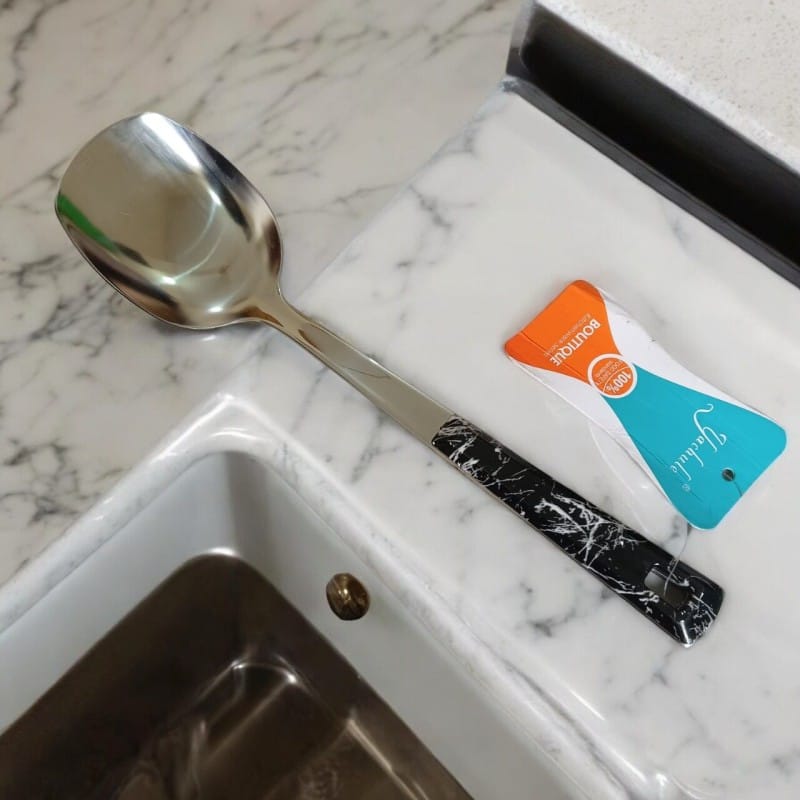 Picture of 10 Inch Stainless Steel Solid Turner Spoon, Silver, Non-Magnetic. Elegant Marble Stone Black Color Cover Plastic Handle. Ideal for Cooking and Serving, Effortless Handling in Any Kitchen Setting.-Silver