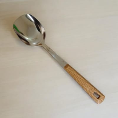Picture of 10 Inch Stainless Steel Solid Turner Spoon, Silver, Non-Magnetic. Wooden Color Cover Plastic Handle for Comfortable Grip. Ideal for Cooking and Serving, Effortless Flipping in Any Kitchen.-Silver