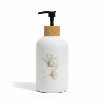 Picture of Elegant white ceramic soap dispenser featuring a luxury gold-toned ginkgo leaf design and a stylish wood-look top with a durable black pump perfect for enhancing your modern bathroom vanity or kitchen sink.-white