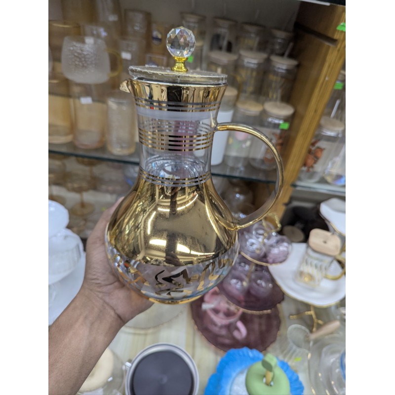 Picture of Premium luxury golden glass jug for dining table stylish 1700ml capacity heat resistant borosilicate glass water pitcher with lid and crystal knob perfect for serving cold juice tea and beverage items.-Gold