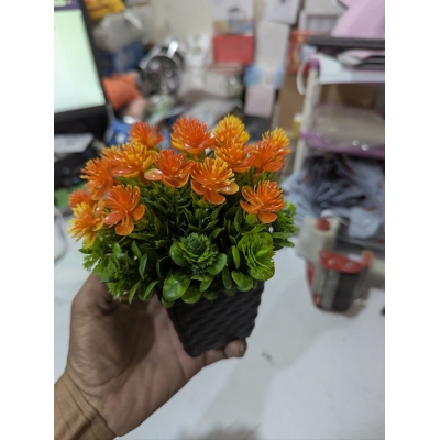 Picture of Premium Artificial Orange Flower Pot for Home Office Table Decoration realistic vibrant faux plant with black plastic weave basket base perfect for living room desk shelf or balcony indoor styling.-Multicolor