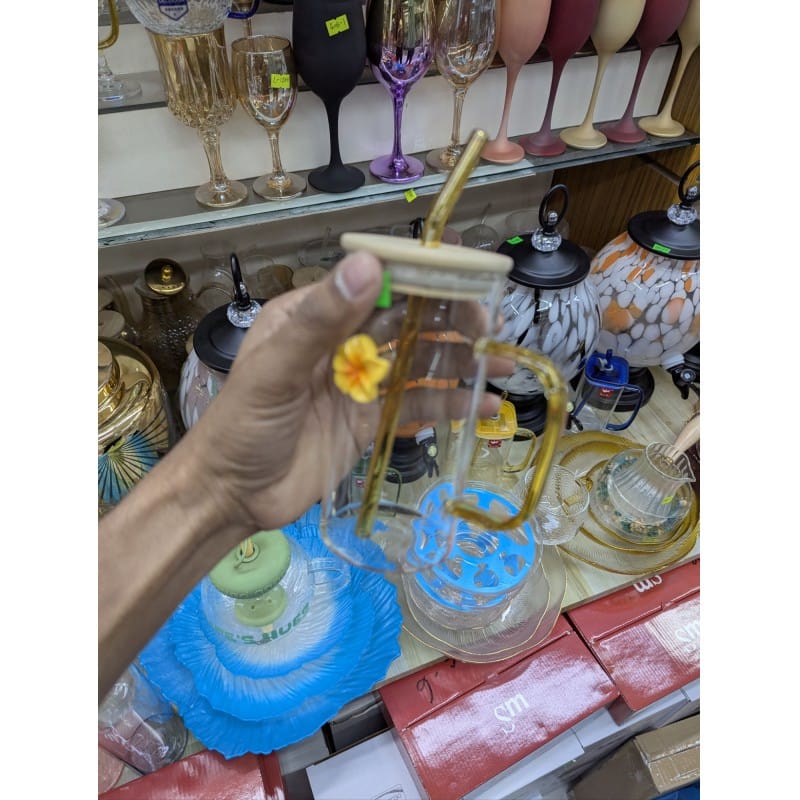Picture of Aesthetic square glass tumbler with bamboo lid and yellow glass handle plus reusable glass straw featuring a cute flower charm perfect for iced coffee milk tea and fruit juice serving at home.-Multicolor