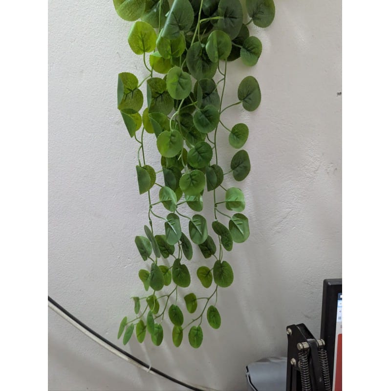 Picture of Premium Artificial Hanging Vine Plant for home decoration features realistic green leaves and long trailing stems perfect for adding a natural touch to your indoor living spaces without any daily maintenance.-Green