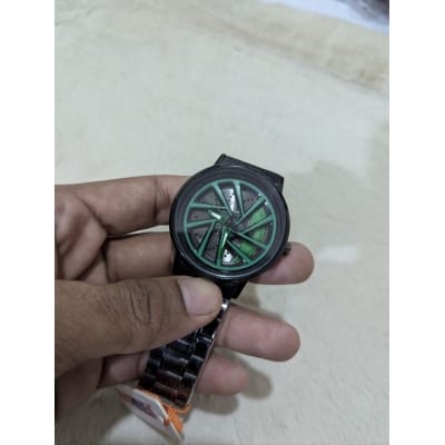 Picture of Premium Car Wheel Rim Rolling Watch for Men Featuring 3D Spinning Hub Metal Dial with Green Brake Caliper Luxury Quartz Movement and Waterproof Stainless Steel Black Strap Stylish Sporty Fashionable Wristwatch.-Multicolor