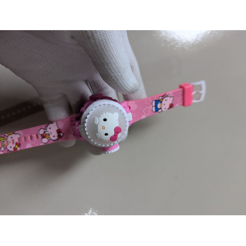 Picture of Hello Kitty Pink Digital Watch for Kids featuring a 3D Character Flip Cover Built-in LED Projector with 24 Cartoon Images and Adjustable Silicone Strap for Girls Birthday Gift and Daily Wear.-Pink