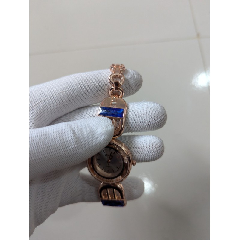 Picture of Luxury Rose Gold Women's Bracelet Watch featuring Elegant Round Dial with Crystal Bezel Blue Sapphire Baguette Gemstones Accents Premium Quartz Movement Stylish Jewelry Timepiece for Formal Occasions and Wedding Party Wear.-Multicolor