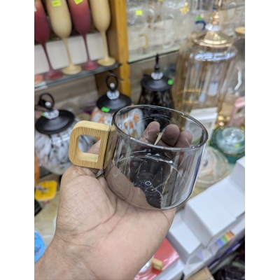 Picture of Premium Smoky Grey Borosilicate Glass Coffee Mug with Ergonomic Natural Walnut Wood Handle, Heat-Resistant Glassware Perfect for Hot Espresso, Latte, and Gourmet Tea Lovers Seeking Elegant and Minimalist Home Decor.-Black