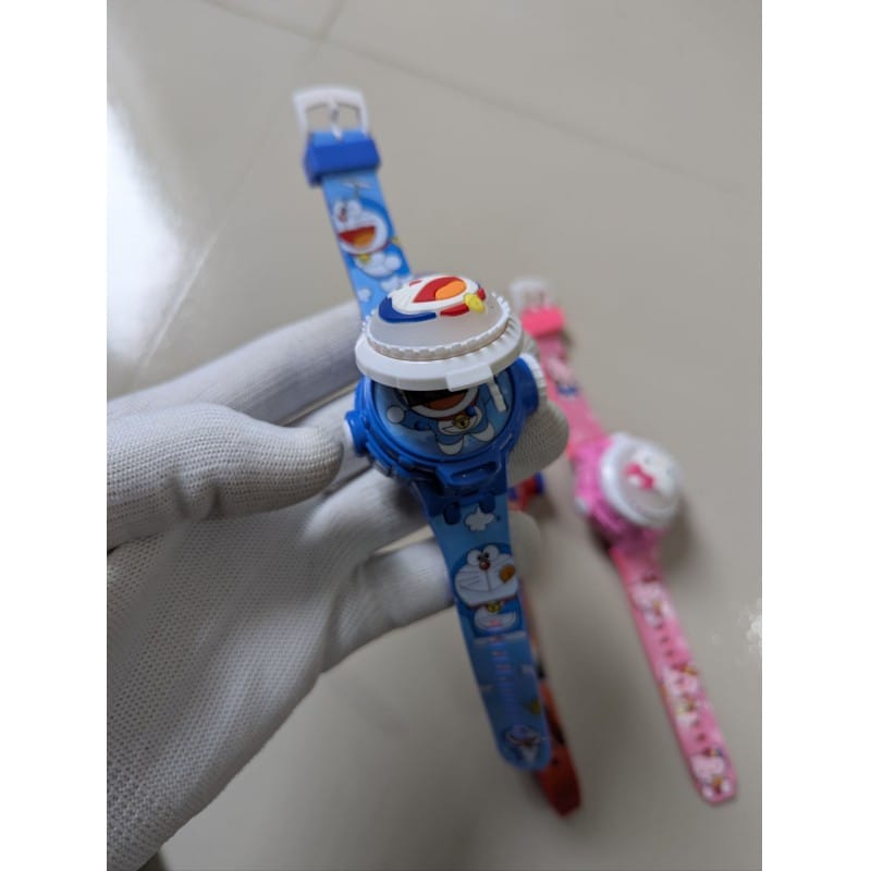 Picture of Doraemon cartoon character digital projector watch for kids featuring twenty-four different rotatable projection images high quality silicone strap adjustable wristband perfect birthday gift idea for boys girls and toddlers online shopping.-Blue