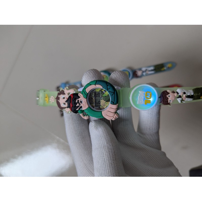 Picture of Ben 10 Kids Digital Watch featuring colorful LED flashing lights and a 3D cartoon character design for boys, with an adjustable silicone strap, durable build, and easy-to-read numeric display for gifts.-Multicolor
