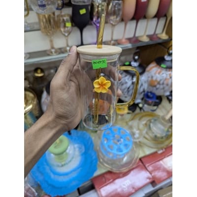 Picture of Aesthetic square glass tumbler with bamboo lid and yellow glass handle plus reusable glass straw featuring a cute flower charm perfect for iced coffee milk tea and fruit juice serving at home.-Multicolor