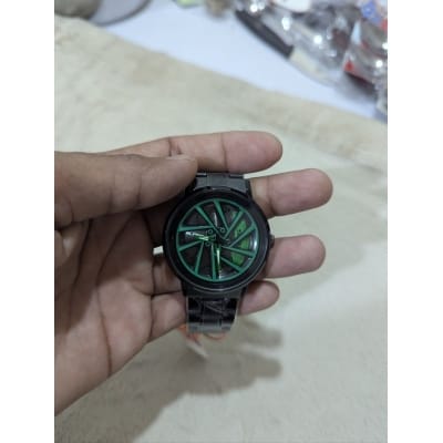Picture of Premium Car Wheel Rim Rolling Watch for Men Featuring 3D Spinning Hub Metal Dial with Green Brake Caliper Luxury Quartz Movement and Waterproof Stainless Steel Black Strap Stylish Sporty Fashionable Wristwatch.-Multicolor