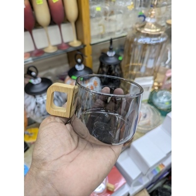 Picture of Premium Smoky Grey Borosilicate Glass Coffee Mug with Ergonomic Natural Walnut Wood Handle, Heat-Resistant Glassware Perfect for Hot Espresso, Latte, and Gourmet Tea Lovers Seeking Elegant and Minimalist Home Decor.-Black