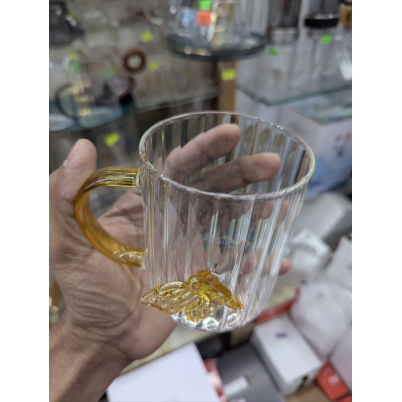 Picture of Premium High Borosilicate Glass Mug Featuring Unique 3D Amber Butterfly Design and Elegant Vertical Stripes with a Comfortable Colored Handle Perfect for Hot Tea Coffee and Stylish Home Decor Aesthetic Kitchenware.-Multicolor