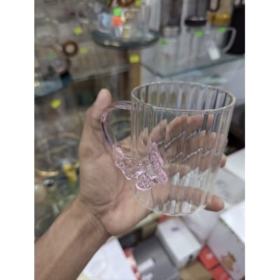 Picture of Elegant 3D butterfly high borosilicate glass mug featuring a heat resistant vertical striped fluted design and pink colored handle perfect for hot coffee herbal tea or as a charming decorative kitchen accessory.-Multicolor