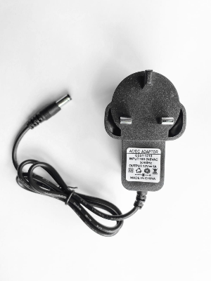 Picture of TP-Link brand power adapter designed for use with wireless routers. - Black