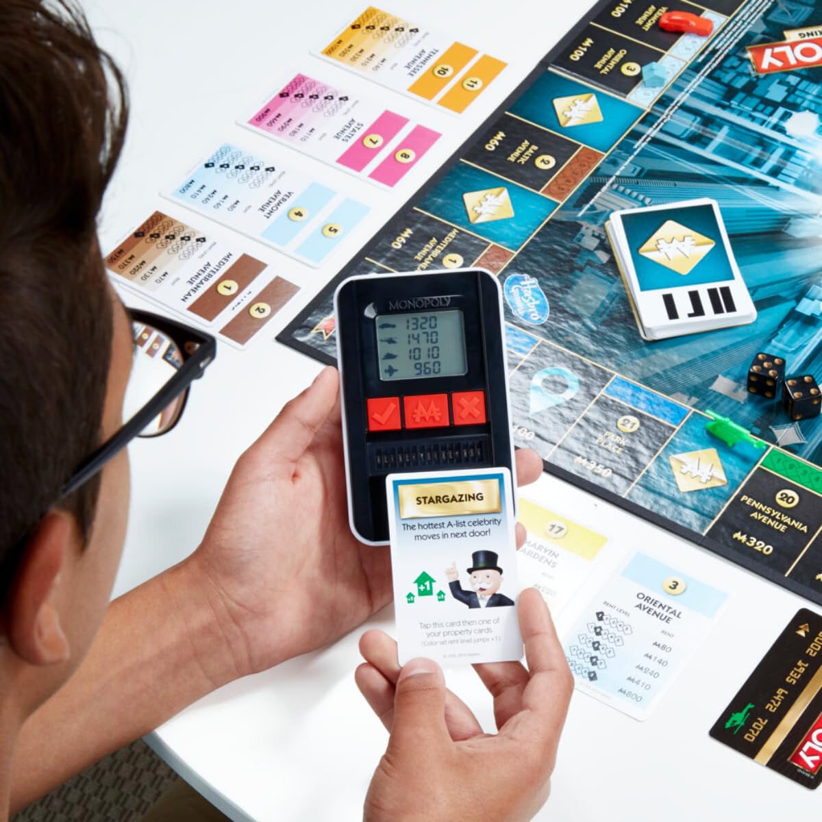 Picture of New Monopoly bord game Super Electronic Board Game, Electronic Banking Unit, Choose Your Rewards, Cashless Gameplay Tap Technology, for Ages 8 and Up,Box English electronic monopoly-Multicolor